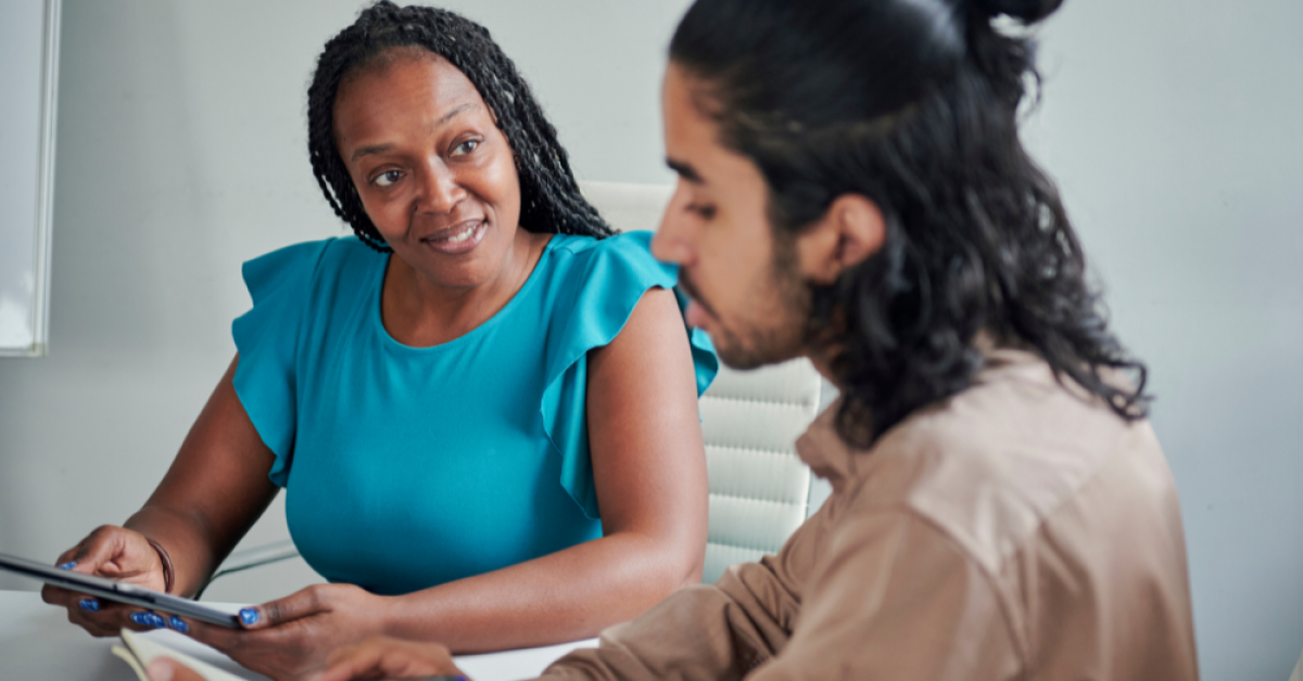 Performance Evaluation Meeting between a Black woman and Indian man